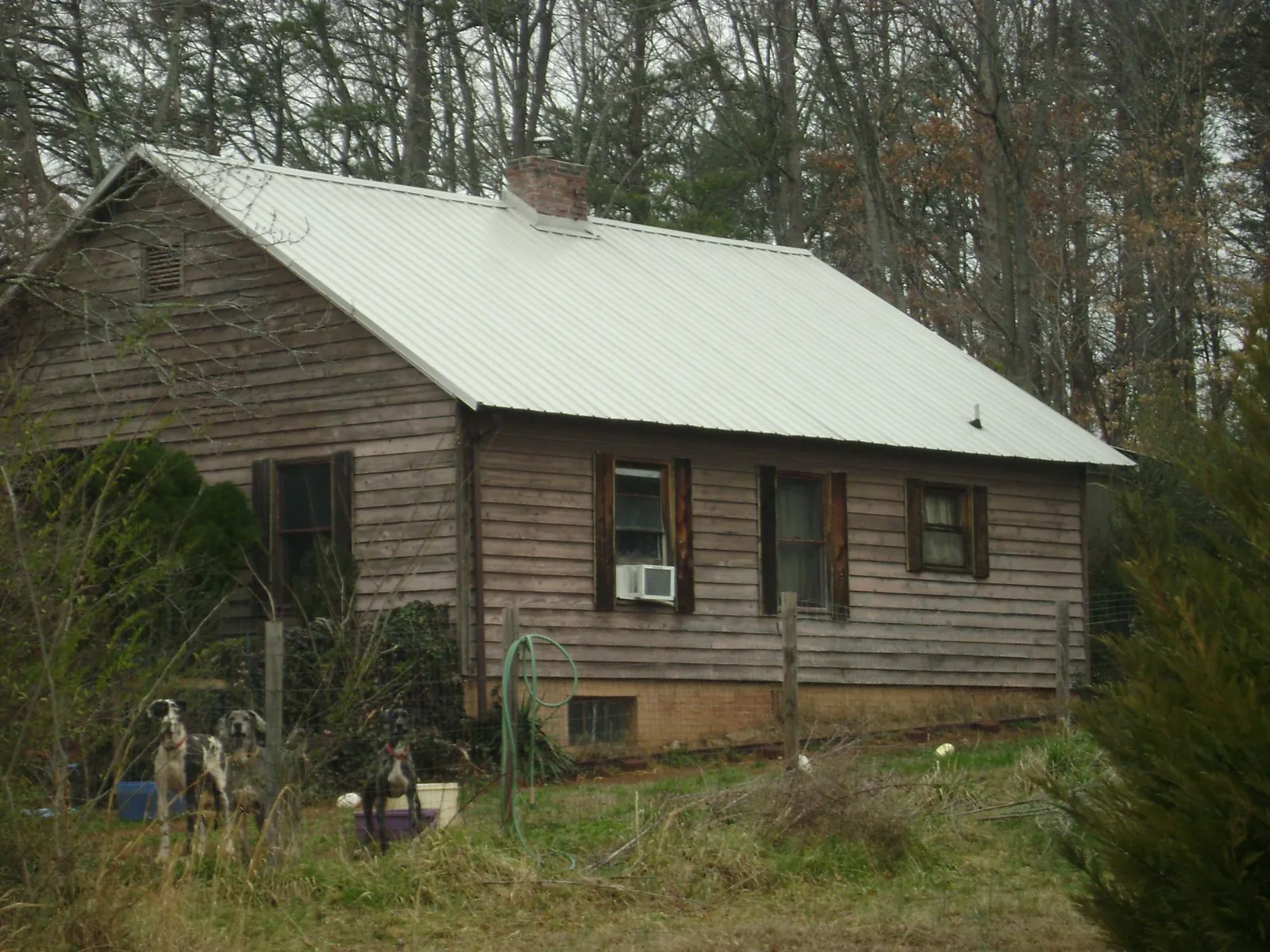 White metal roof on an old wood sided farmhouse, from a Metal Roof Installation job in Cohutta